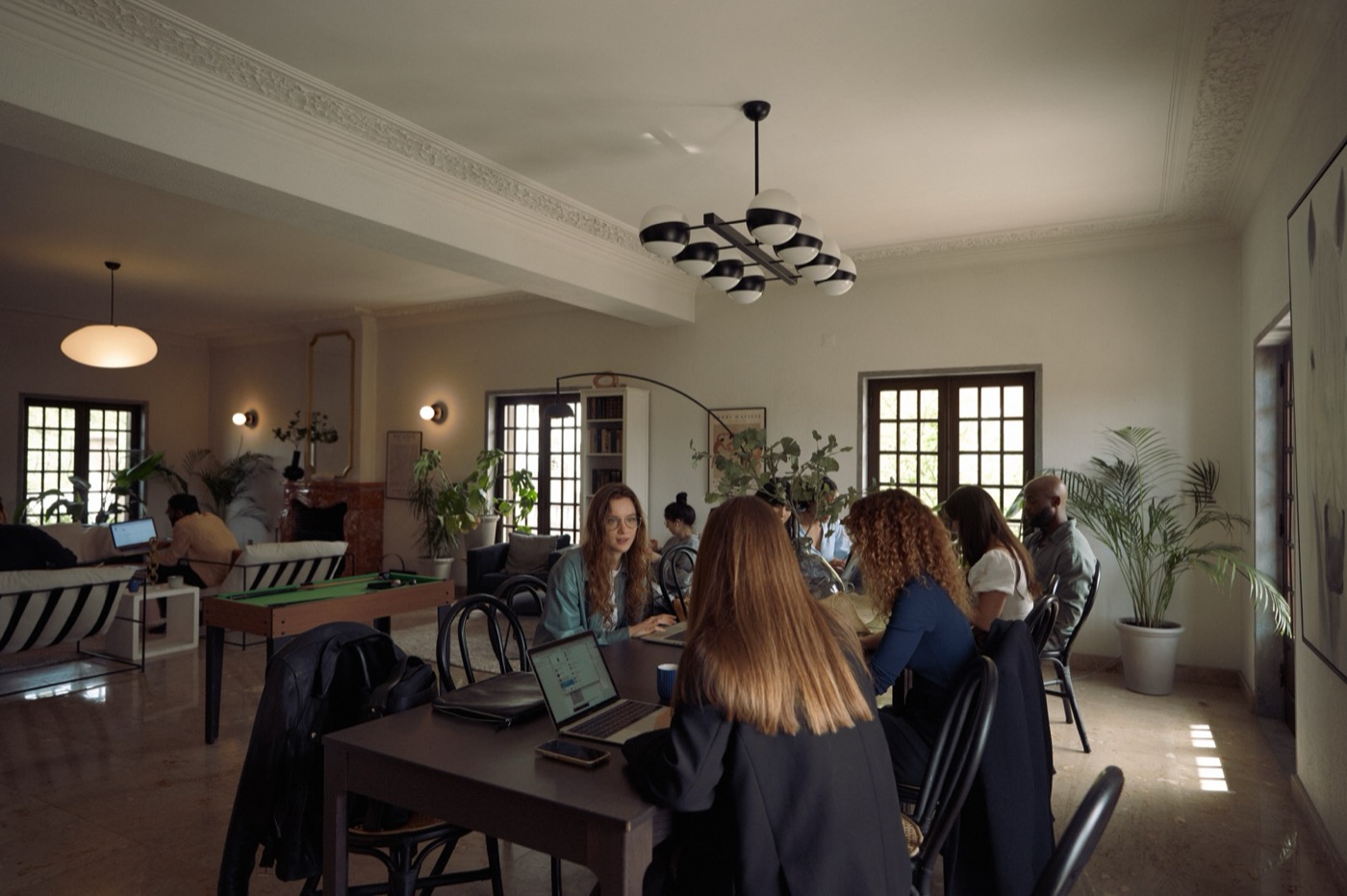 A team working together at the long table in the salon